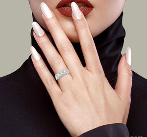 Diamond engagement ring or diamond anniversary ring with cushion cut diamonds surrounded by a halo of diamonds on lady finger