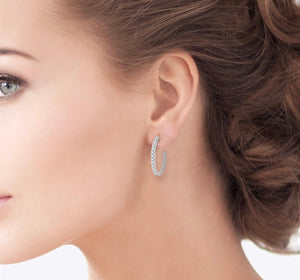 Diamond hoop earrings in 14kt white gold on lady