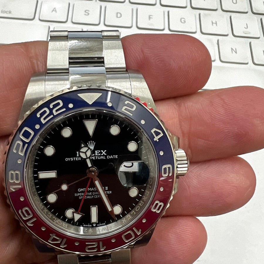 Authentic recently purchased GMT watch held in hand
