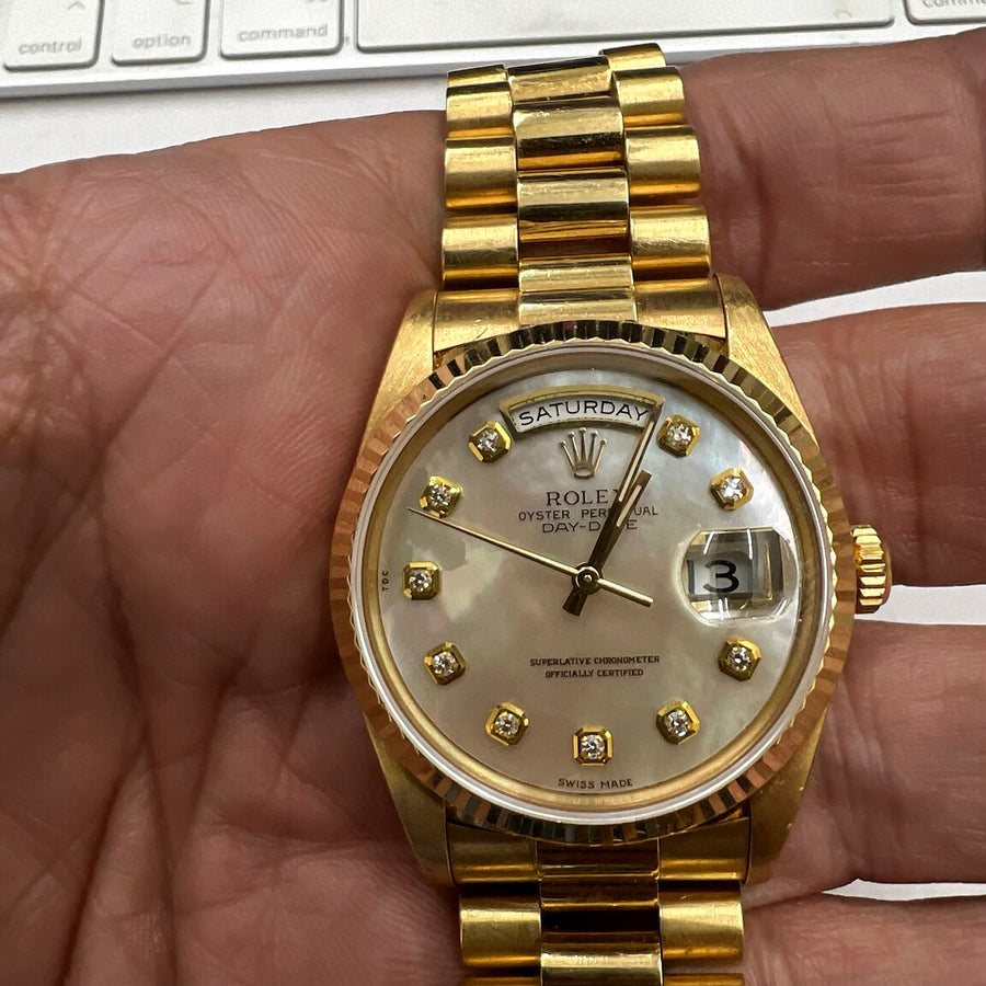 Authentic recently purchased gold day-date watch held in hand