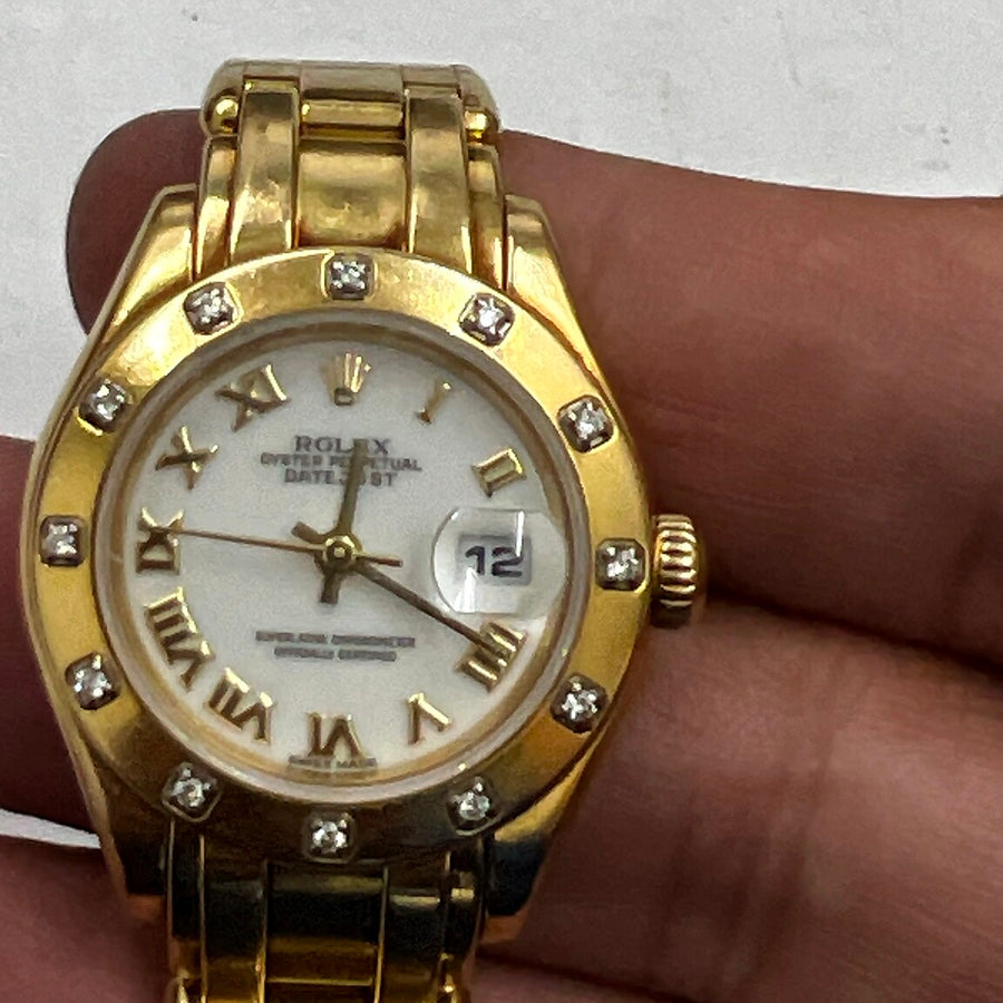 Authentic recently purchased yellow-gold watch held in hand