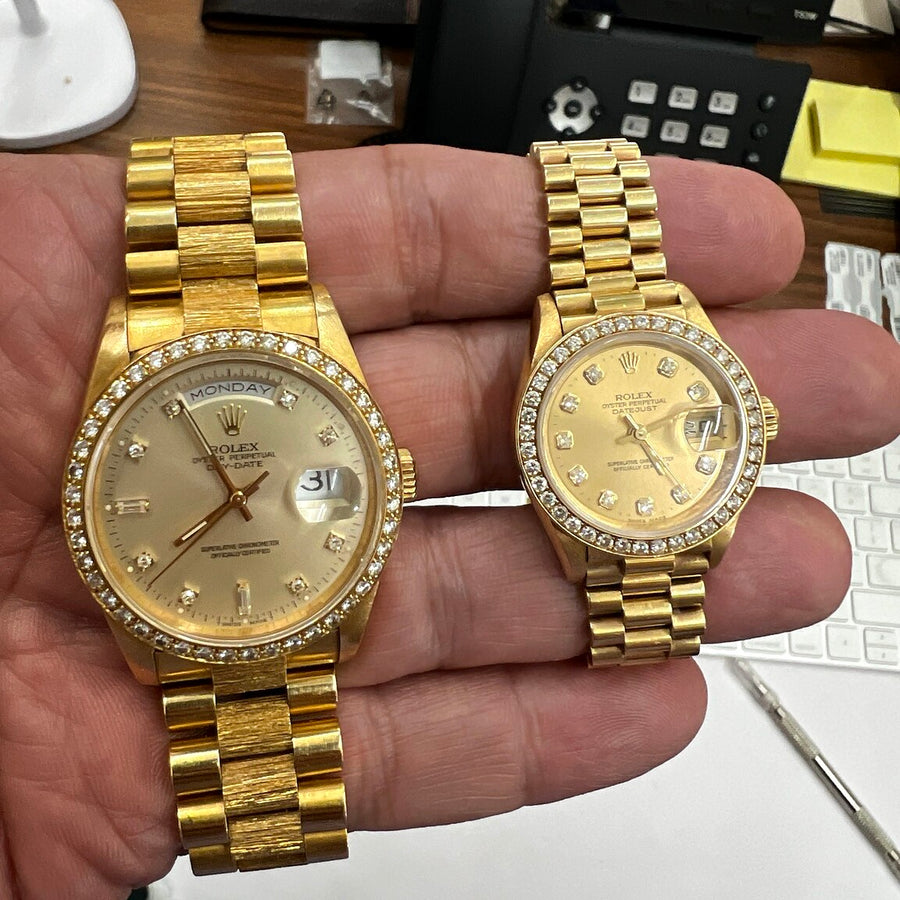 Authentic recently purchased pair of gold watches held in hand