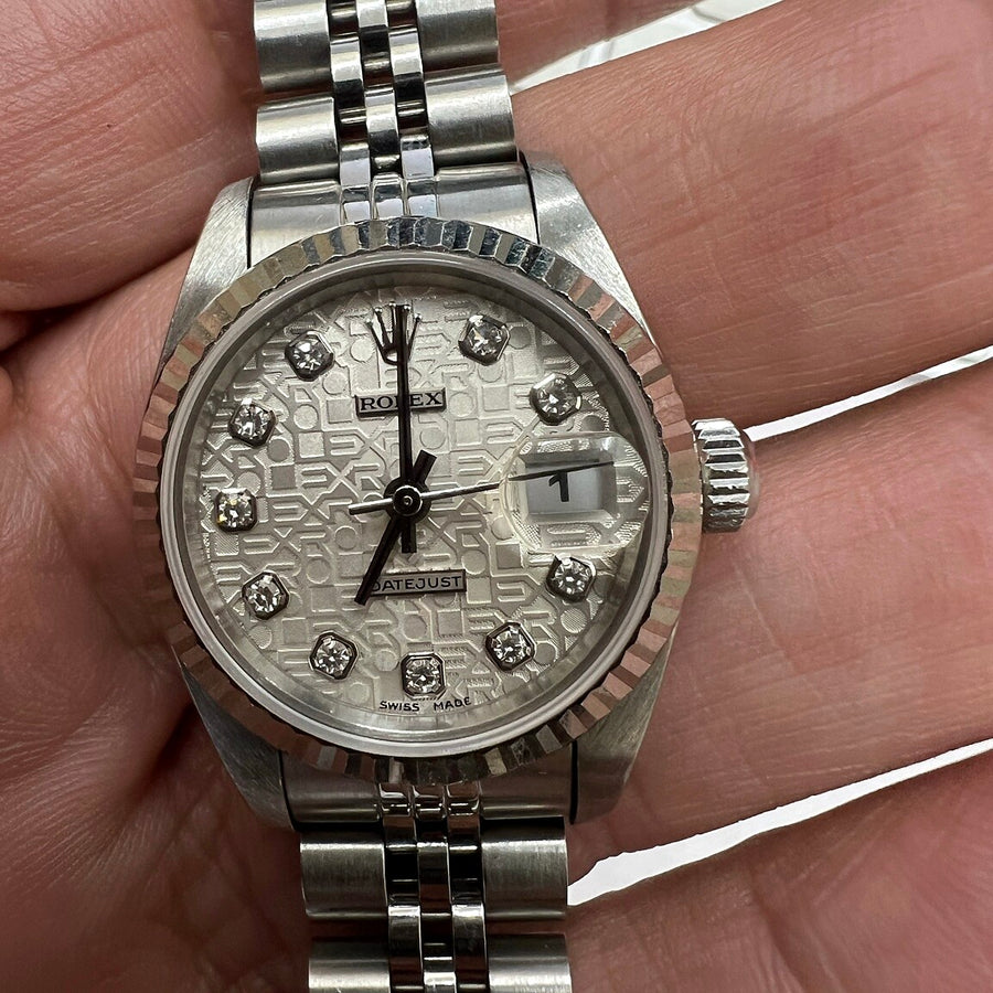 Authentic recently purchased silver-tone watch held in hand
